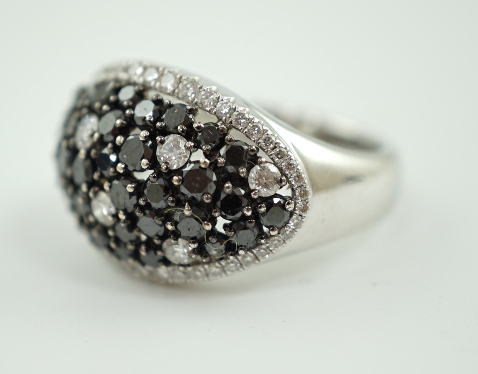 A modern pair of 750 white gold and two colour diamond cluster dress ring